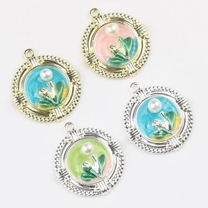 Detailed view of floral enamel charms with faux pearls and gold alloy borders for DIY jewelry