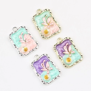Detail showing rectangular enamel flower pendants with wavy edges and pearl inlay for DIY jewelry