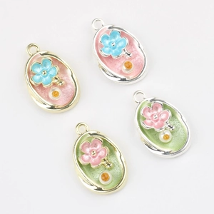 Detailed view of floral charms with pearls and enamel for DIY bracelet making