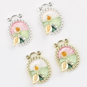 Detail of Monet Garden enamel charms with floral patterns and twisted metal rope edges