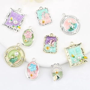 Detail of pastel alloy charms with pearl insets for DIY jewelry making sets