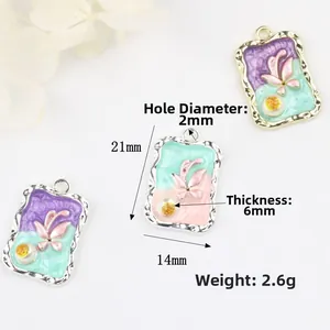 Detailed view of enamel butterfly charm with 21mm x 14mm dimensions and floral patterns