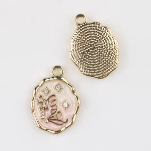 Detail of butterfly enamel pendant with crystals and wave edge in gold alloy