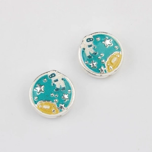 Macro shot of blue enamel space charms with astronauts and moon for DIY jewelry making