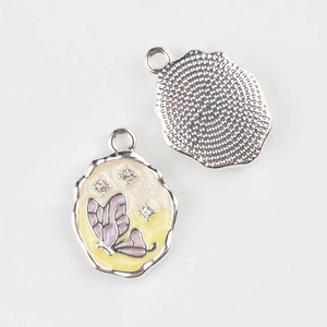 Detailed macro view of a butterfly enamel pendant showing the front and metallic back