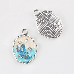 Detailed front and back view of blue butterfly enamel pendant with sparkling crystals