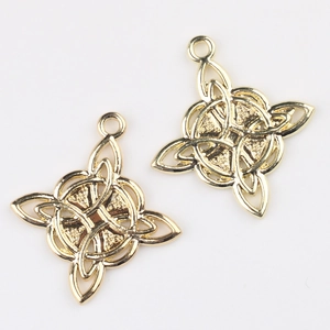 Detailed view of two gold Celtic knot alloy pendants for DIY jewelry making