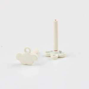 Detail view of white cloud-shaped earring charms with matte spray paint finish