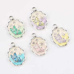 Detail view of colorful butterfly pendants with enamel coating and rhinestone accents