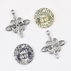 Detailed view of Celtic knot charms and All-Seeing Eye pendants in silver and gold alloy