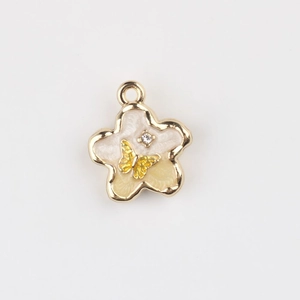 Detail of flower pendant with enamel petals, gold butterfly, and zircon center