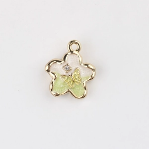 Detail of flower pendant with green gradient enamel, gold butterfly and zircon stone