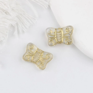 Detailed macro view of Czech glass butterfly beads with gold edges for DIY jewelry making