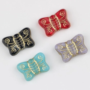 Handmade butterfly glass beads with gold painted patterns in red, black, purple, and blue