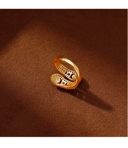 Close-up of golden snake ring with zircon micro-pave details on a velvet base