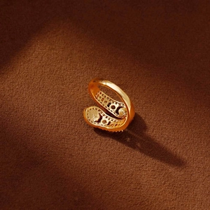 Luxury gold snake ring with sparkling zircons and red agate accents in a layered design