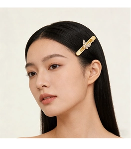 Vue détaillée d'une pince à cheveux papillon dorée ornée de zircons sur cheveux