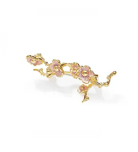 Vue détaillée d'une broche branche de prunier en émail rose et métal doré poli