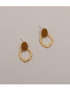 Detailed close-up of matte brown enamel stud and wavy golden irregular hoop earrings