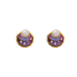 Gouden oorbellen met paarse zirkoon schelp en witte parels in een gedraaid frame
