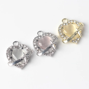 Detail of heart pendants with cat eye stones and pavé crystals for DIY jewelry