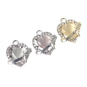 Three heart-shaped resin pendants with sparkling zircon borders and small star accents