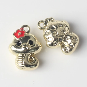 Detail showing two cartoon golden snake charms with red flower and honeycomb back design