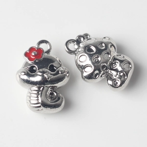 Macro view of cartoon snake pendant with red flower and hollow hemispherical charm