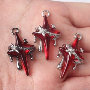 Star-shaped red resin cross pendant with silver metal wrap and sparkling rhinestone accent