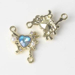 Detailed view of a gold-plated butterfly connector with blue heart gemstone and pearls