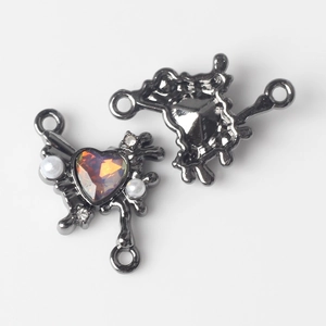 Macro shot of butterfly connector with AB heart stone and pearl for DIY jewelry