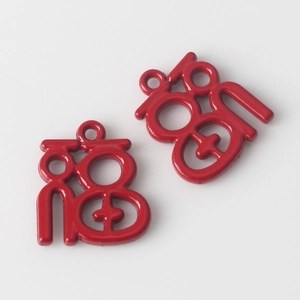 Detail view of two red hollow Fu pendants with glossy finish for DIY jewelry making