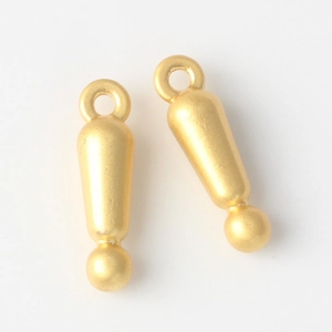 Close-up of matte gold alloy exclamation mark charms for DIY jewelry making and pendants