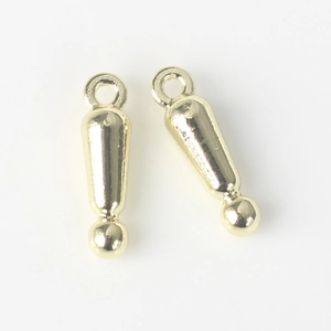 Macro detail of gold-toned alloy exclamation mark pendants for DIY jewelry making