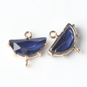 Detail of fan-shaped blue crystal charms with gold-plated edges for DIY jewelry making