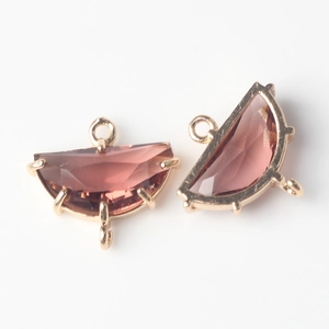 Detail of faceted rose quartz teardrop charms with gold plated frames for DIY jewelry