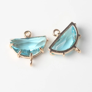 Close-up of fan-shaped natural stone pendants with gold-plated bezel and triple loops