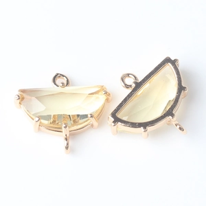Macro shot of faceted semi-circular natural stone connector with gold plated brass edge