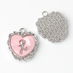 Detail of heart pendants with rose embossing and star texture on the back side
