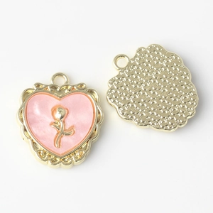 Detailed close-up of heart-shaped rose pendants showing front relief and starry back texture