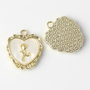 Close-up of heart resin pendant with gold rose and starry textured back for DIY jewelry
