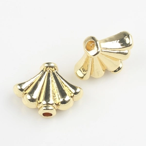 Close-up of golden fan-shaped alloy spacer beads with polished finish for DIY jewelry