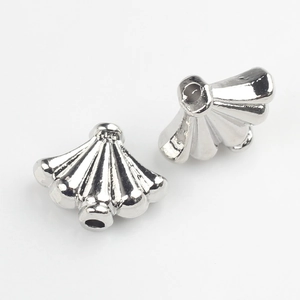 Macro view of silver shell-shaped alloy spacer beads for DIY jewelry making