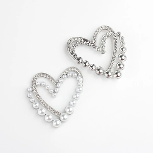 Detail of silver heart pendants with faux pearls and sparkling zircon stones