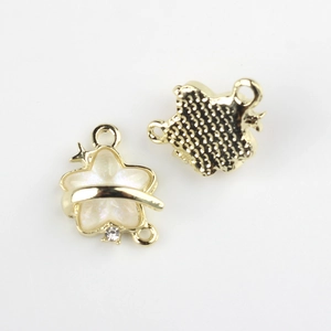 Detailed view of gold alloy star charms with resin inlay and three loops for DIY jewelry