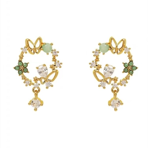 Golden floral wreath earrings with green beads and cubic zirconia charms on white background