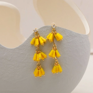 Elegante goldene Ohrringe mit langen gelben Fransenperlen und funkelnden Zirkonia-Steckern