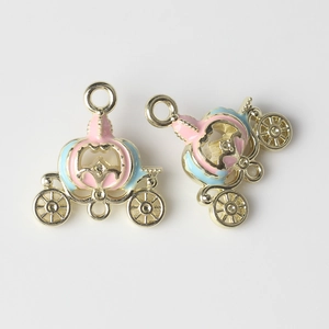 Detailed view of colorful enamel pumpkin carriage charms for DIY jewelry making