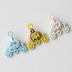 Detailed view of colorful alloy pumpkin carriage charms for DIY jewelry making and crafts