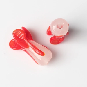 Detailed top view of red and pink resin DIY clips showing translucent texture and design